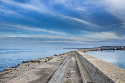 Pier over sea against sky