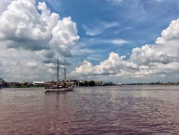 Sailboat in sea against sky