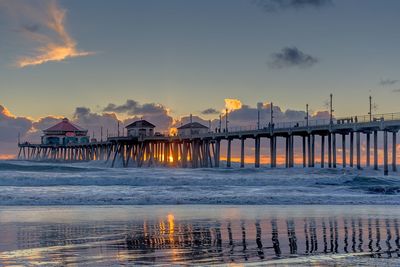 Pier on sea at sunset