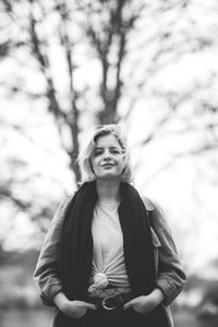 Full length of woman standing by tree