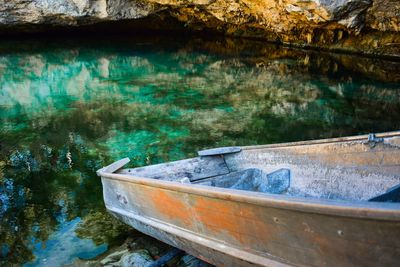 Abandoned boat moored in lake