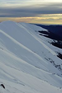 Aerial view of snowcapped landscape against sky