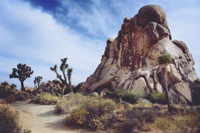 Rock formations on landscape against sky