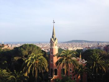 Panoramic view of buildings and trees against sky in city