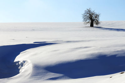 Scenic view of snow covered landscape against sky