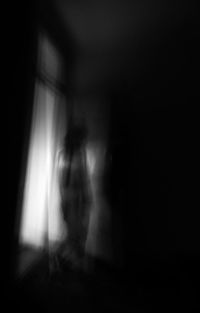 Blurred motion of person shadow in dark room