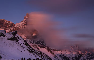 Scenic view of snowcapped mountains against sky during sunset