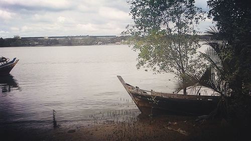 Scenic view of lake against cloudy sky