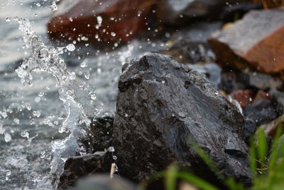 Close-up of water splashing on rocks