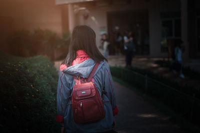 Rear view of woman walking outdoors