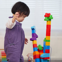 Baby girl playing with toy blocks