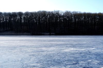 Frozen lake against sky during winter