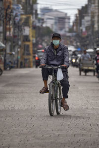 Man riding bicycle on road