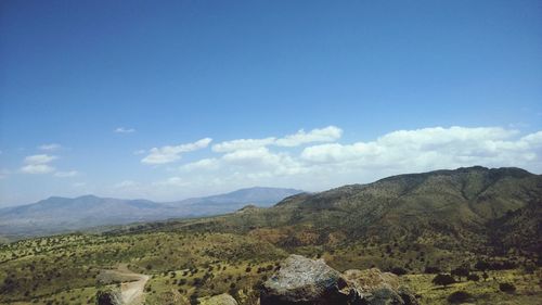 Scenic view of mountains against blue sky