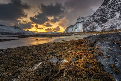 Scenic view of snowcapped mountains against sky during sunset