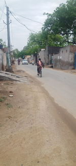 People riding motorcycle on road in city