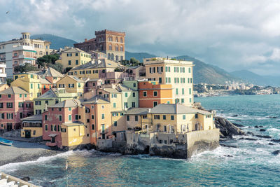 Italy, liguria, genoa, pastel colored houses in boccadasse district