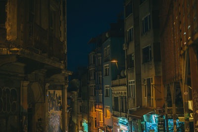 Low angle view of buildings in city at night