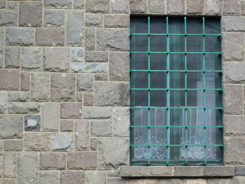 Stone wall with latticed window.