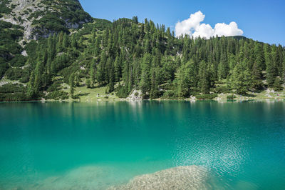 Scenic view of swimming pool by lake against sky