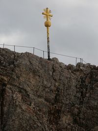 Low angle view of communications tower against sky