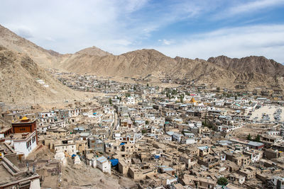 High angle view of buildings against cloudy sky