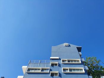 Low angle view of building against clear blue sky