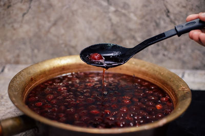 Close-up of person hand pouring tea