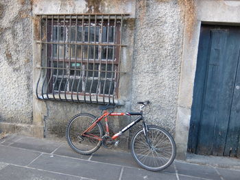 Bicycle parked against window