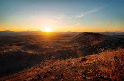 Scenic view of landscape against sky during sunset