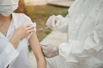 Doctor giving vaccine to patient