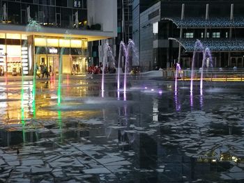 Fountain in city at night