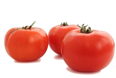 Close-up of tomatoes against white background