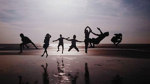 People on beach at sunset