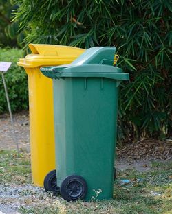 Close-up of garbage can on field