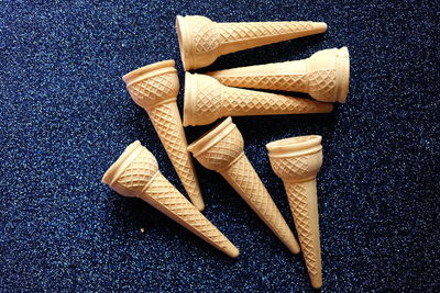 Directly above shot of ice cream cones against black background