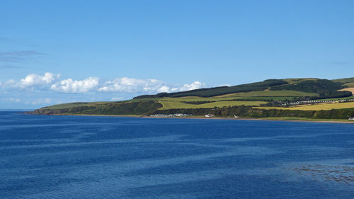 Scenic view of sea against blue sky