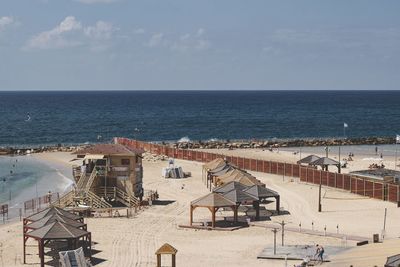 High angle view of beach by sea against sky