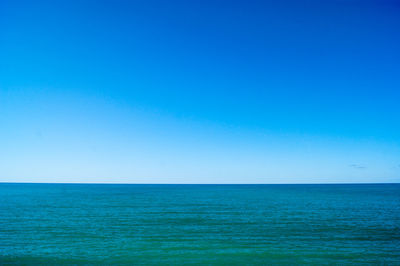 Scenic view of sea against clear blue sky