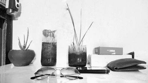 Row of sunglasses on table against wall at home