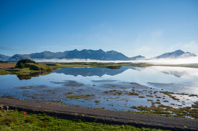 Scenic view of lake against blue sky