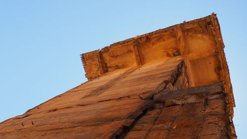 Low angle view of rock formation against clear sky