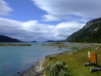 Scenic view of sea and mountains against sky