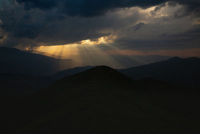 Sun rays through the clouds in the mountains