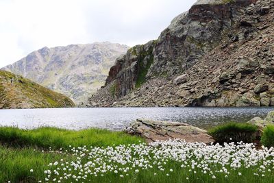 Scenic view of lake by mountain against sky