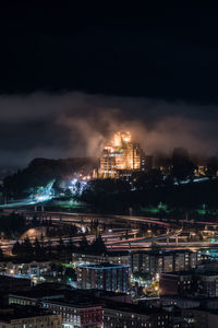 Illuminated cityscape against sky at night
