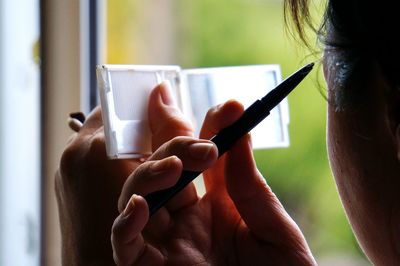 Cropped image of woman holding camera