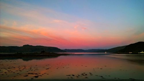 Scenic view of lake against romantic sky at sunset