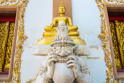 Statue outside temple against building