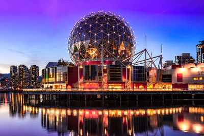 Illuminated ferris wheel at night